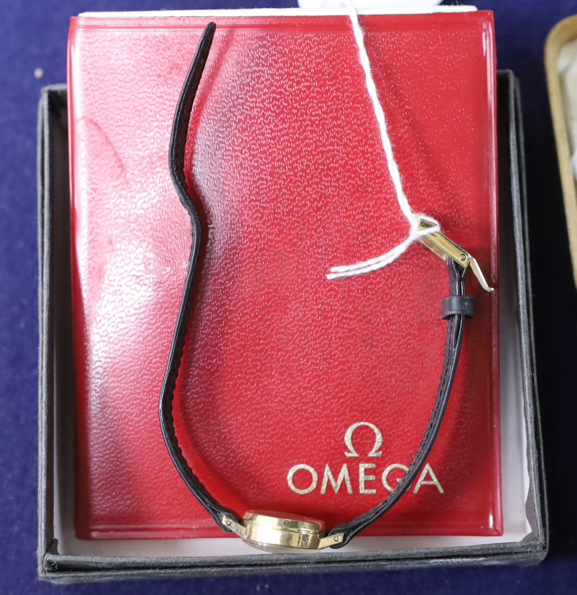 A lady's 1960's 9ct gold Omega manual wind wrist watch, on a leather strap with Omega buckle, the case back with inscription, with paperwork, no box.